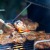 a person grilling meat on a grill