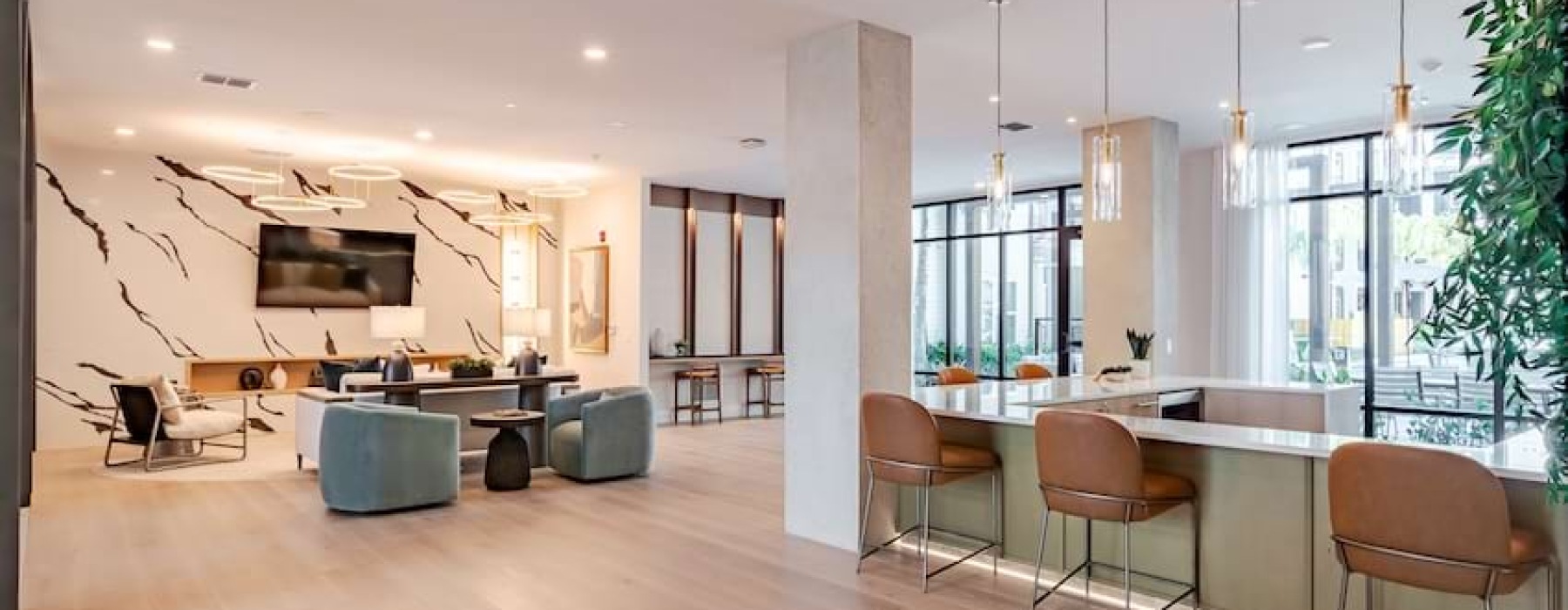 a clubroom with a tv, a couch and chairs
