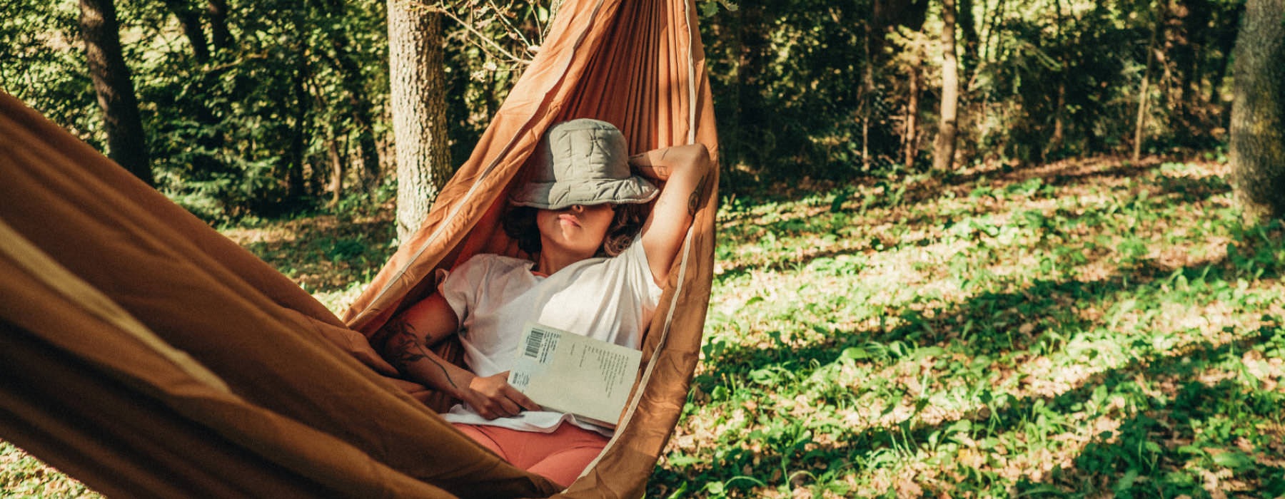 woman sleeping in a hammock in the woods