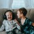 young brothers sit together on a large couch