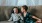 young brothers sit together on a large couch